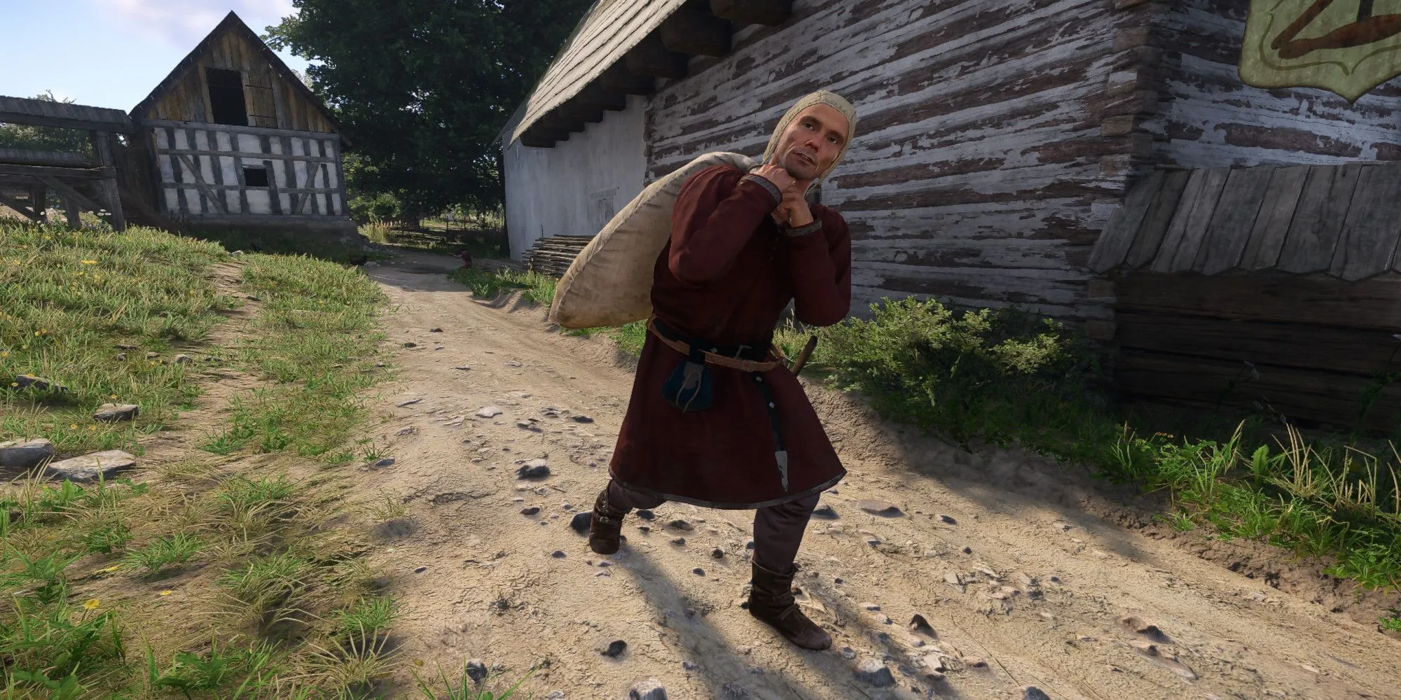 Người đàn ông vác bao tải nặng trong Kingdom Come Deliverance 2, minh họa sức chứa hành lý