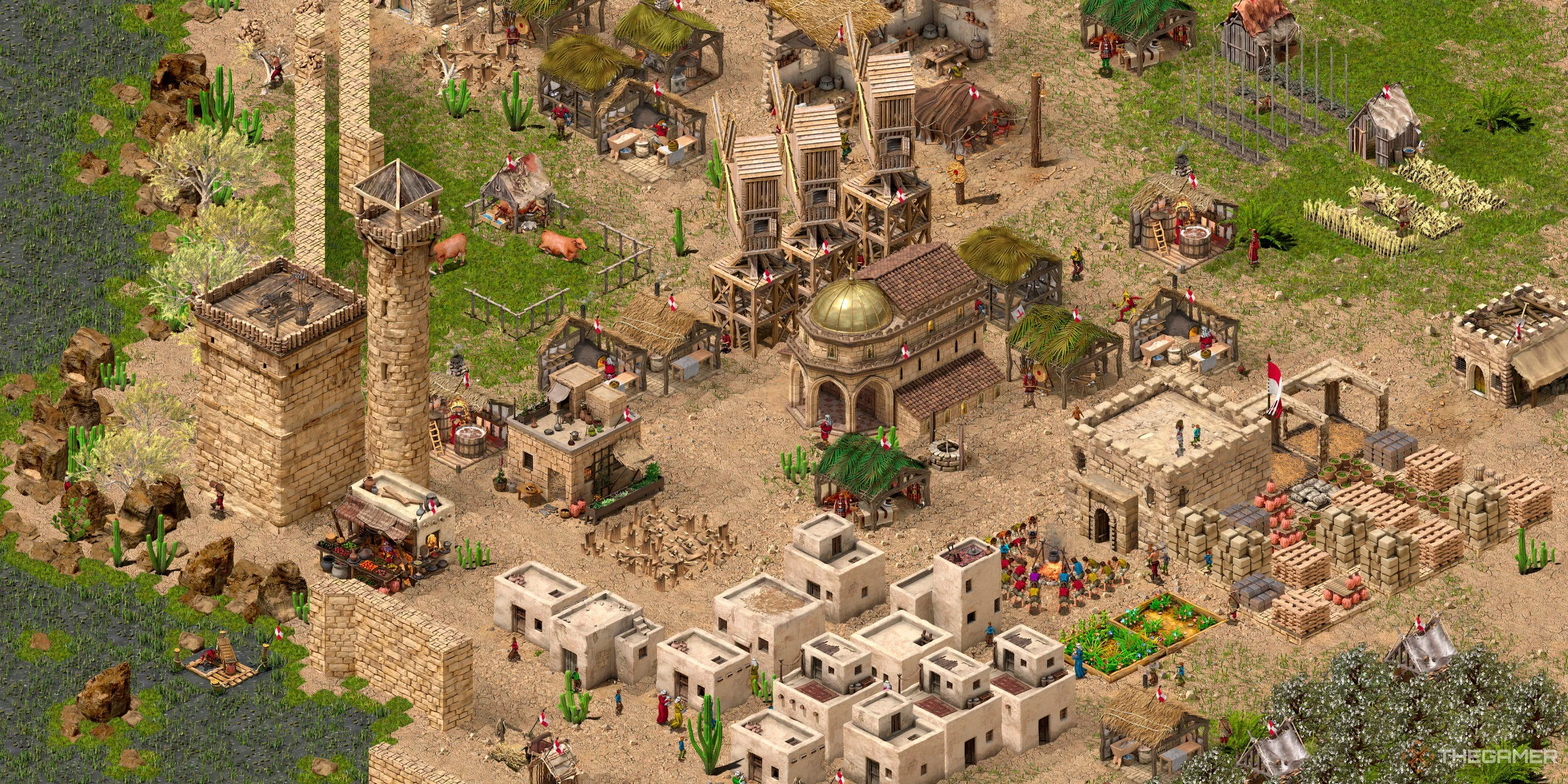 Toàn cảnh một khu định cư thời trung cổ với tường thành và các tòa nhà sản xuất trong Stronghold Crusader Definitive Edition.
