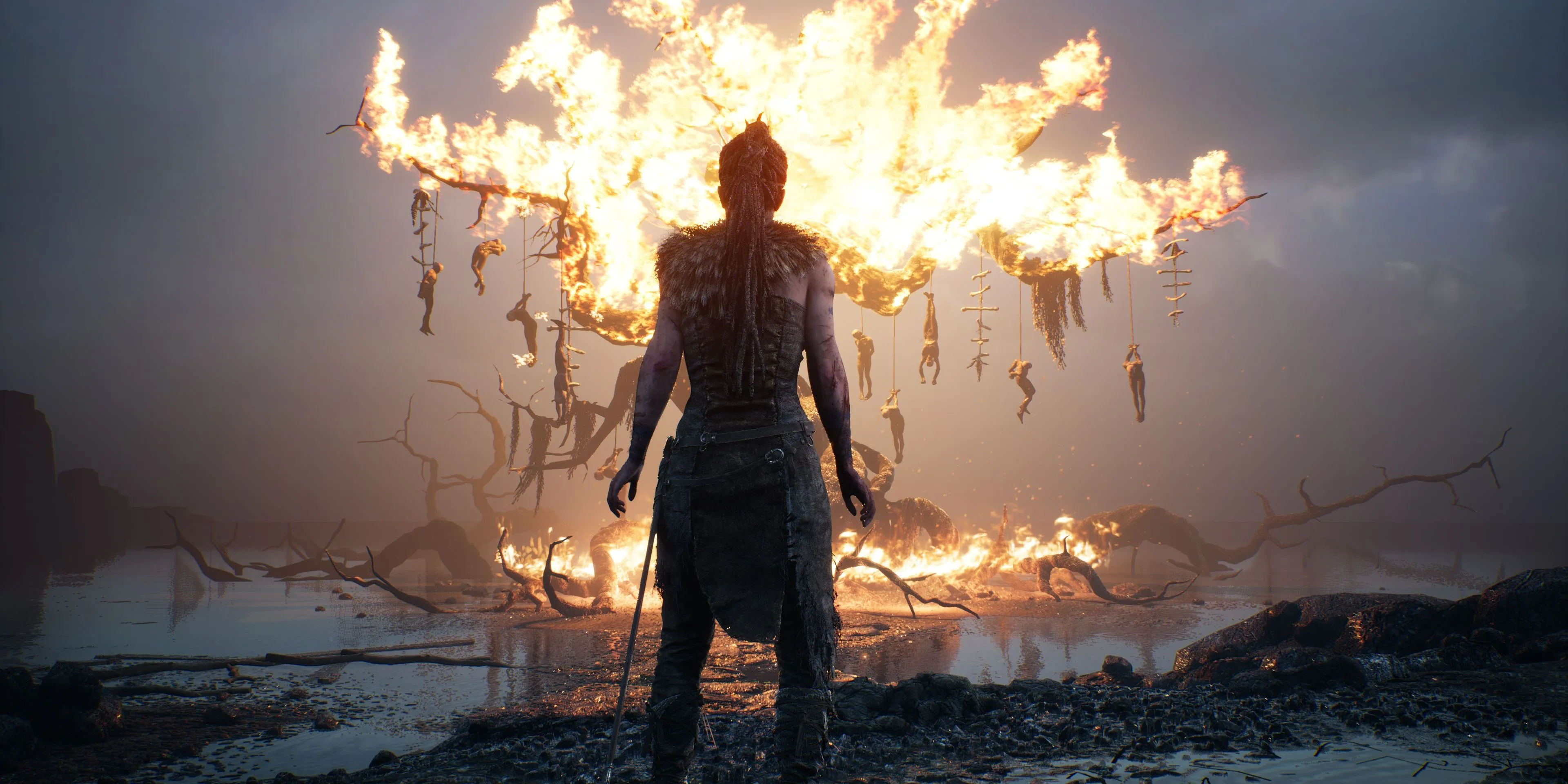 Senua đối mặt với lửa cháy và bóng tối, thể hiện cuộc đấu tranh nội tâm trong Hellblade: Senua's Sacrifice